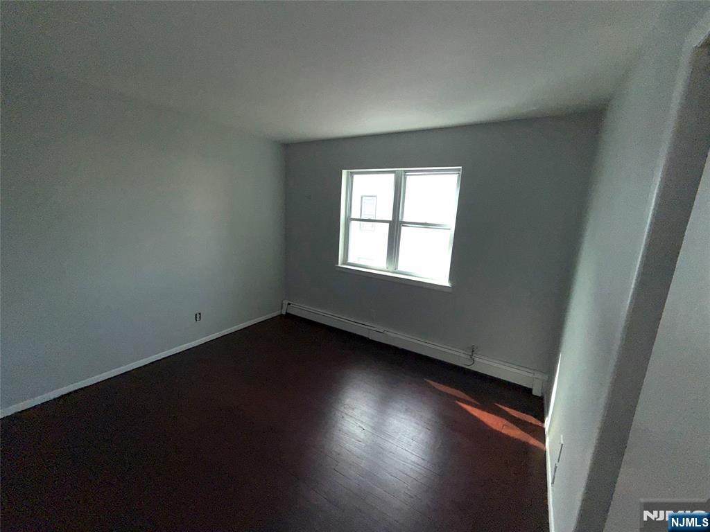 224-226 Clinton Street, Unit 224 Paterson, NJ 07522 - Photo 7 of 12 an empty room with wooden floor and windows