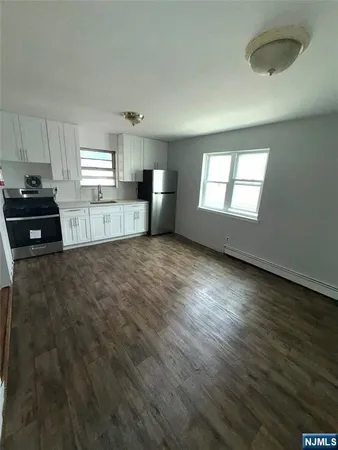 a kitchen with stainless steel appliances a refrigerator sink and stove