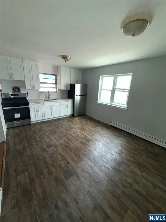 224-226 Clinton Street, Unit 224 Paterson, NJ 07522 - Photo 9 of 12 a kitchen with stainless steel appliances a refrigerator sink and stove