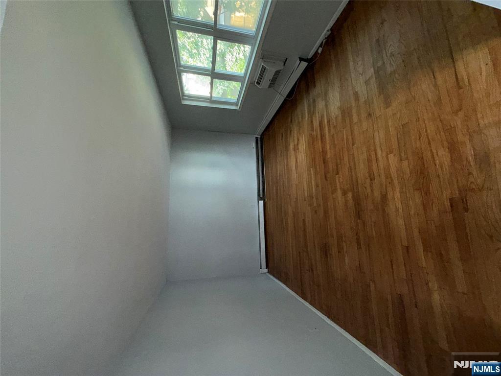 224-226 Clinton Street, Unit 224 Paterson, NJ 07522 - Photo 10 of 12 an empty room with wooden floor and windows