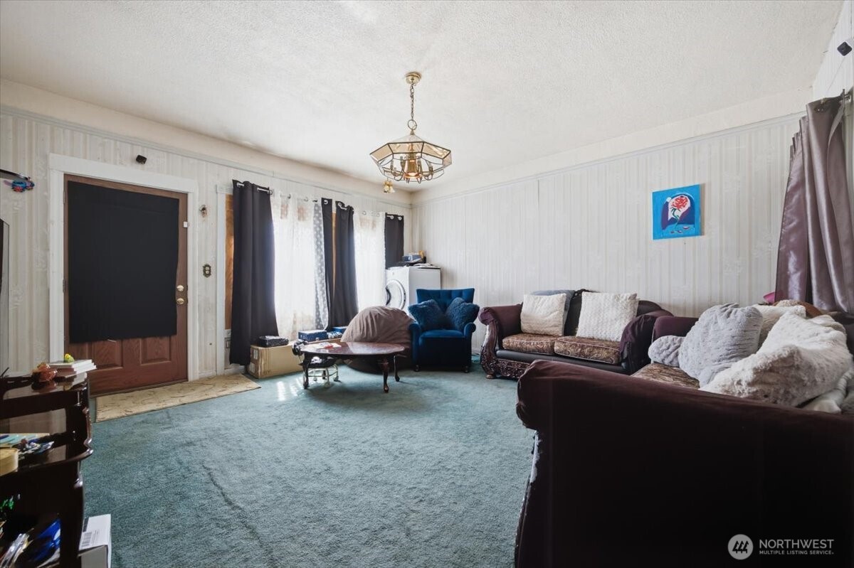 802 South 11th Avenue Pasco, WA 99301 - Photo 2 of 24 a living room with furniture wooden floor and a chandelier