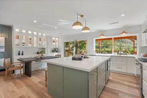 a kitchen with a large window and sink