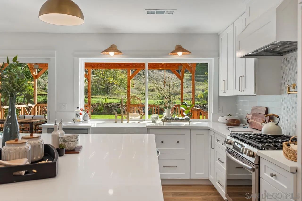 1155 Pepper Drive El Cajon, CA 92021 - Photo 16 of 62 a kitchen with stainless steel appliances a stove a sink and a refrigerator