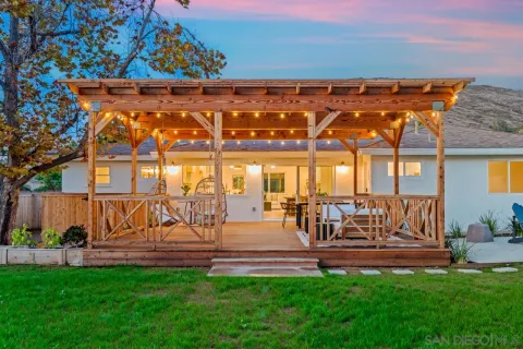 a view of a house with a backyard