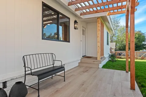 a living room with furniture a fireplace and a large window