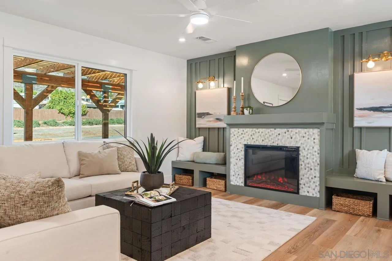 1155 Pepper Drive El Cajon, CA 92021 - Photo 55 of 62 a living room with furniture a fireplace and a large window