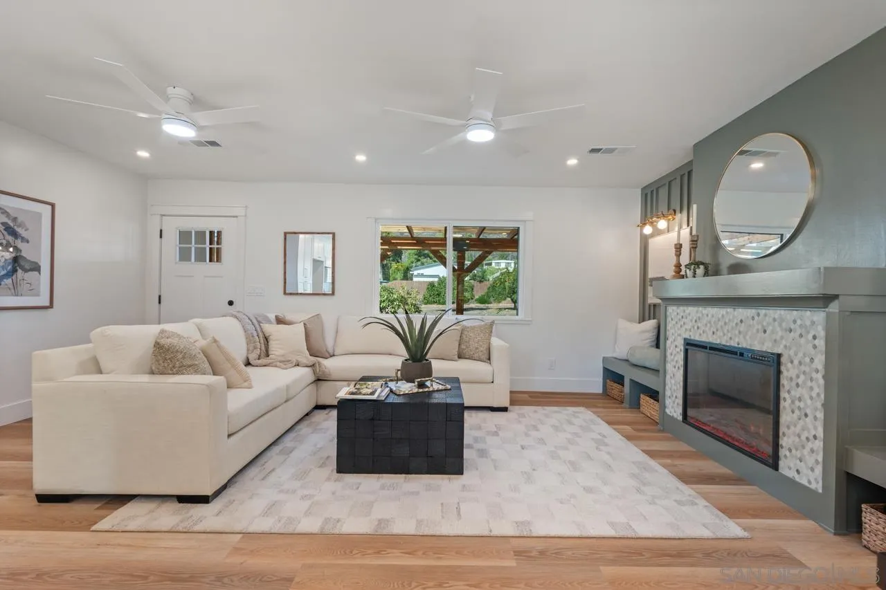 1155 Pepper Drive El Cajon, CA 92021 - Photo 56 of 62 a living room with furniture a fireplace and a potted plant
