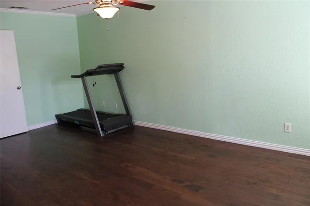 a view of a room with wooden floor