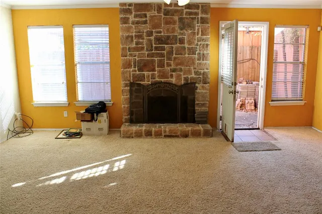 a view of a livingroom with a fireplace and a window