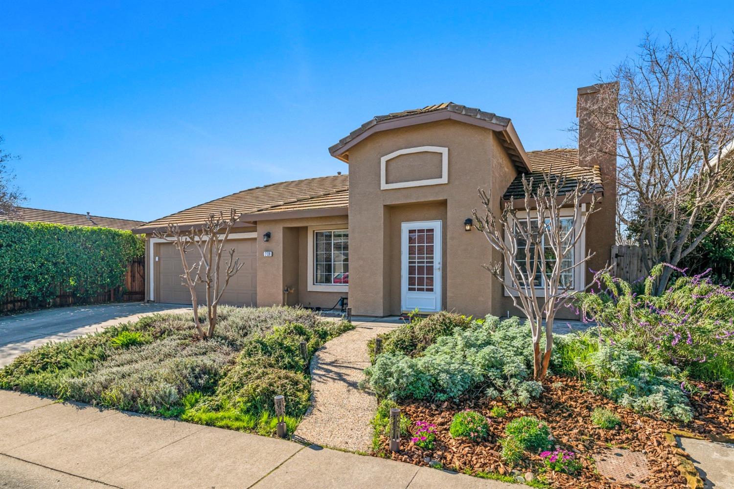 a front view of a house with garden