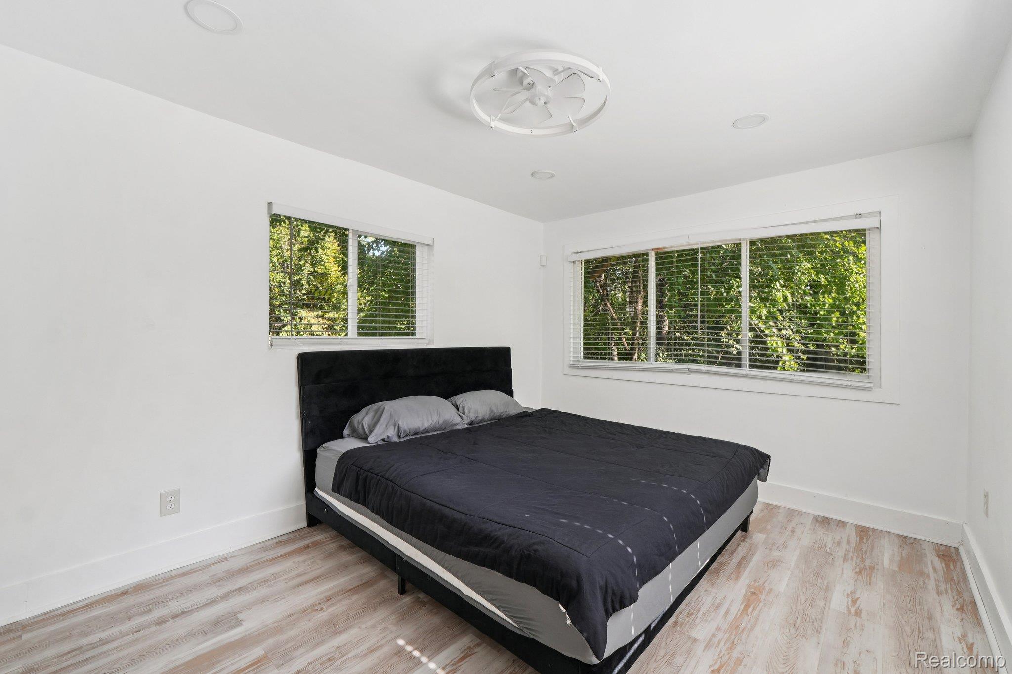 16210 Inverness Street Detroit, MI 48221 - Photo 14 of 29 Wood-finish flooring, recessed lighting, and a ceiling-mounted fan fixture