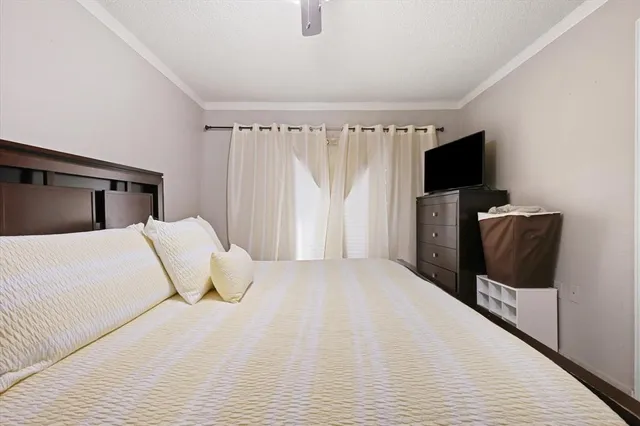 a bedroom with a bed and a flat screen tv