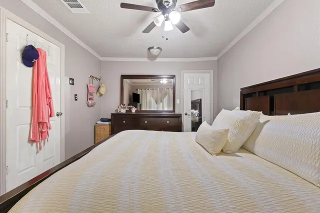 a large bedroom with a large bed and a chandelier