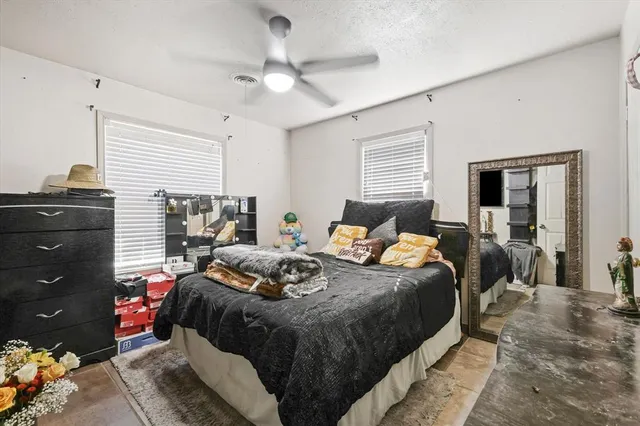 a bedroom with bed and window