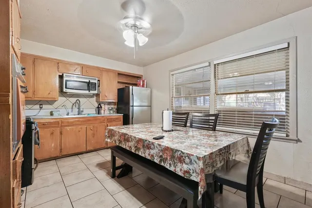 a kitchen with granite countertop a sink appliances counter space and refrigerator