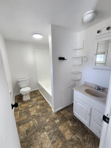 an empty room with a chandelier fan