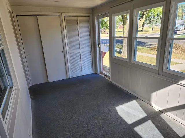 a view of a house with a yard and large trees