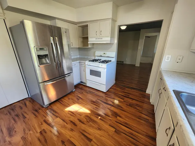 a kitchen with stainless steel appliances a refrigerator sink and microwave