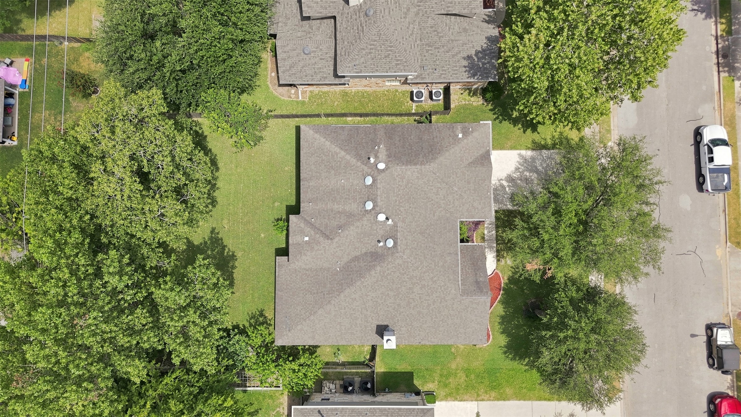 1116 Canyon Maple Road Pflugerville, TX 78660 - Photo 28 of 32 An aerial perspective showcases the composition of the shingle roof and surrounding greenery.