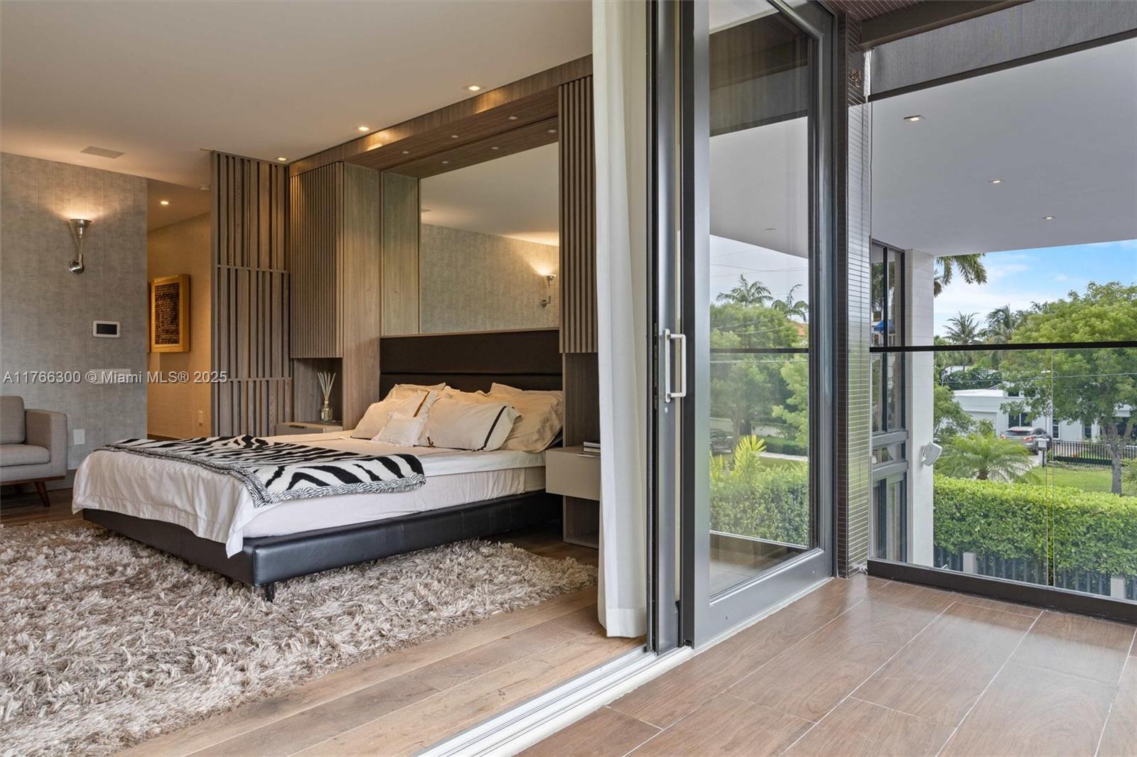 610 Harbor Circle Key Biscayne, FL 33149 - Photo 29 of 71 a view of a bedroom with floor to ceiling window and wooden floor