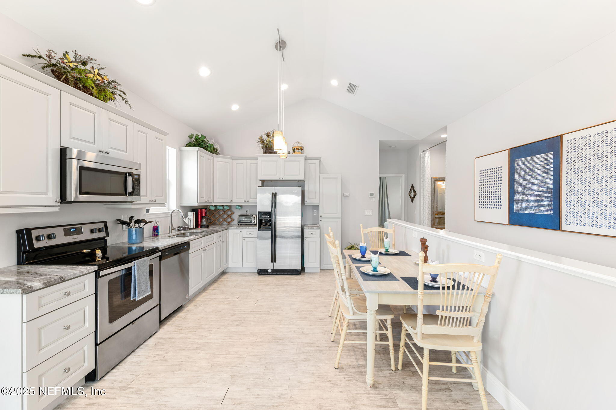 239 Riberia Street St. Augustine, FL 32084 - Photo 21 of 88 a kitchen with stainless steel appliances kitchen island granite countertop a sink and cabinets
