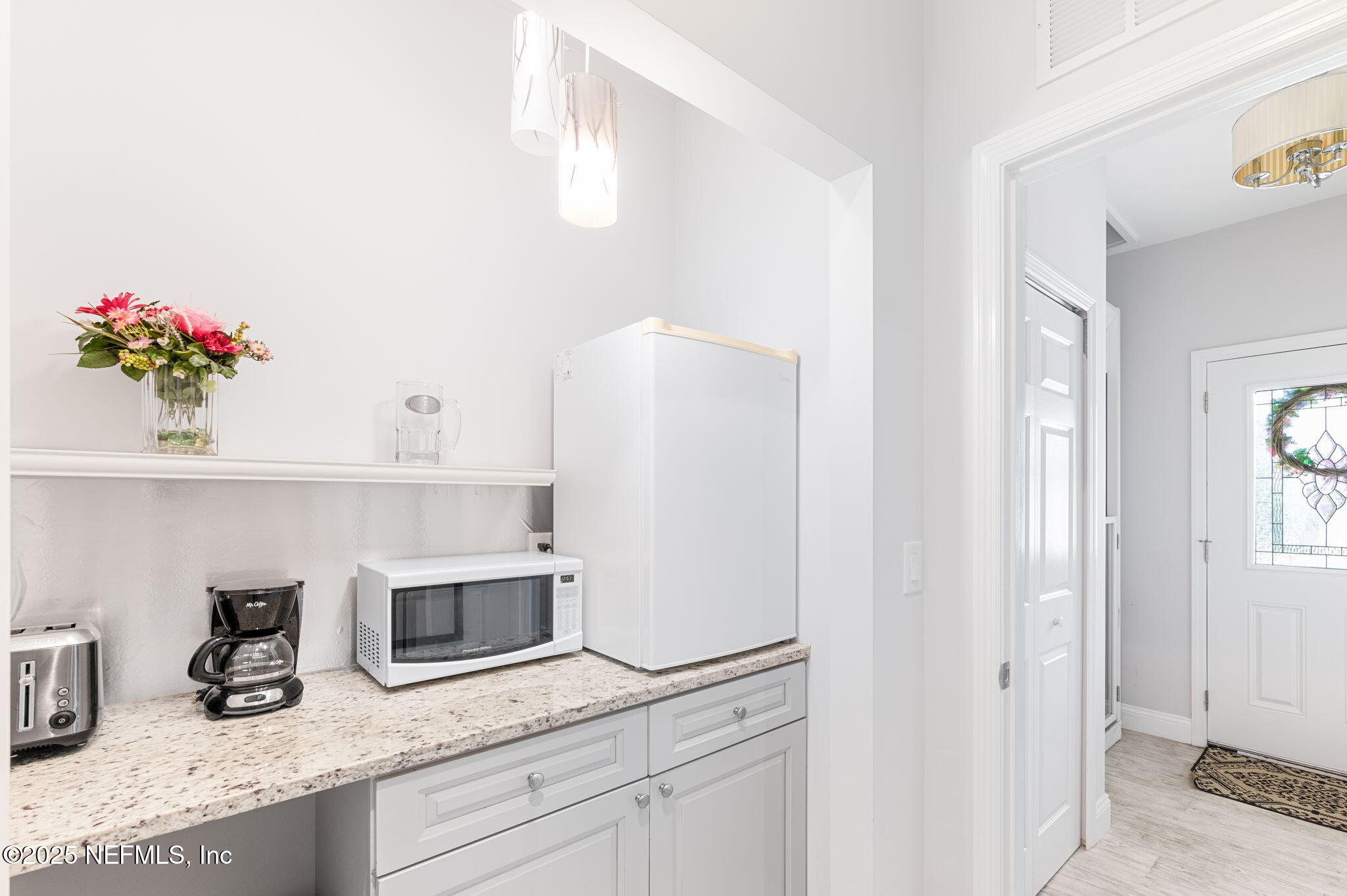 239 Riberia Street St. Augustine, FL 32084 - Photo 41 of 88 a kitchen with granite countertop white cabinets and white appliances