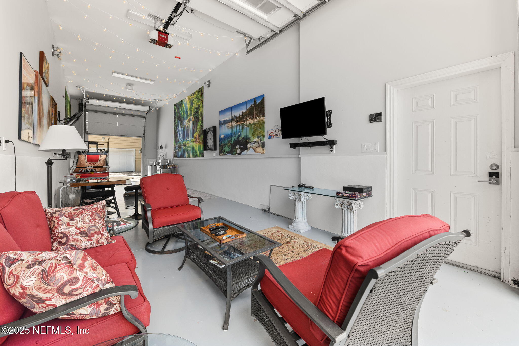 239 Riberia Street St. Augustine, FL 32084 - Photo 77 of 88 a living room with furniture a flat screen tv and a window