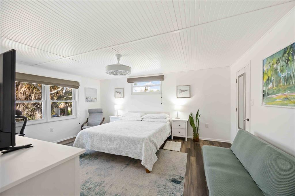 5075 North Beach Road, Unit B4 Englewood, FL 34223 - Photo 15 of 79 a bedroom with a large bed and a couch