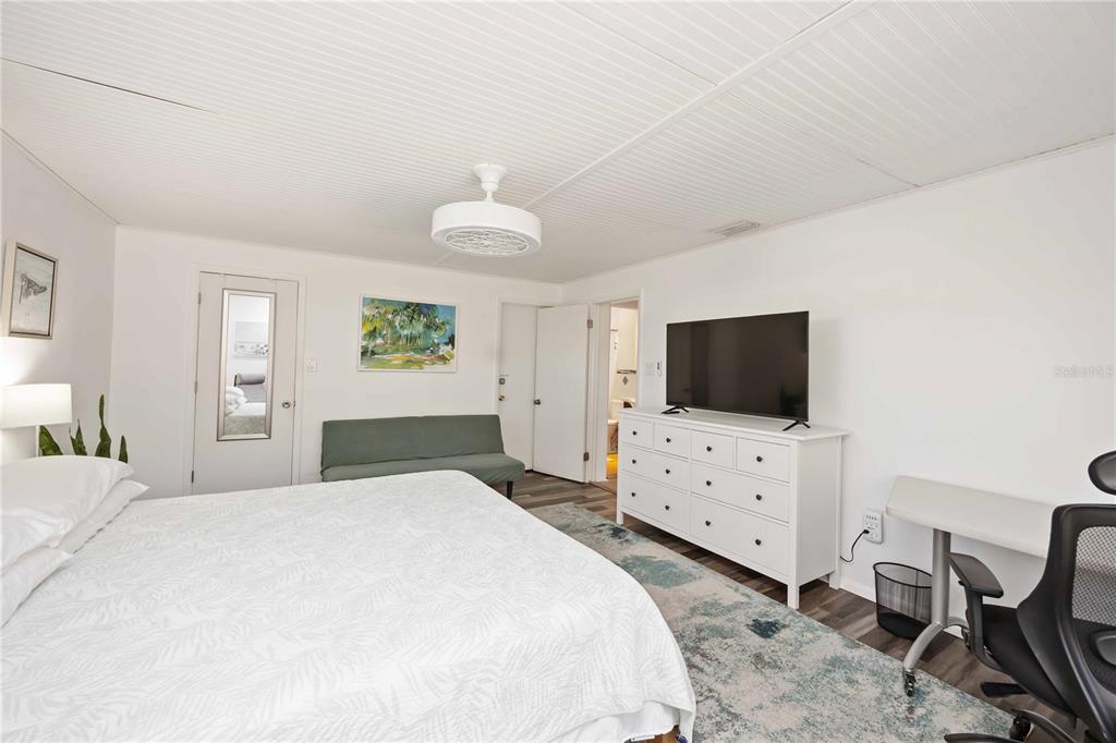 5075 North Beach Road, Unit B4 Englewood, FL 34223 - Photo 16 of 79 a bedroom with a bed and a flat screen tv