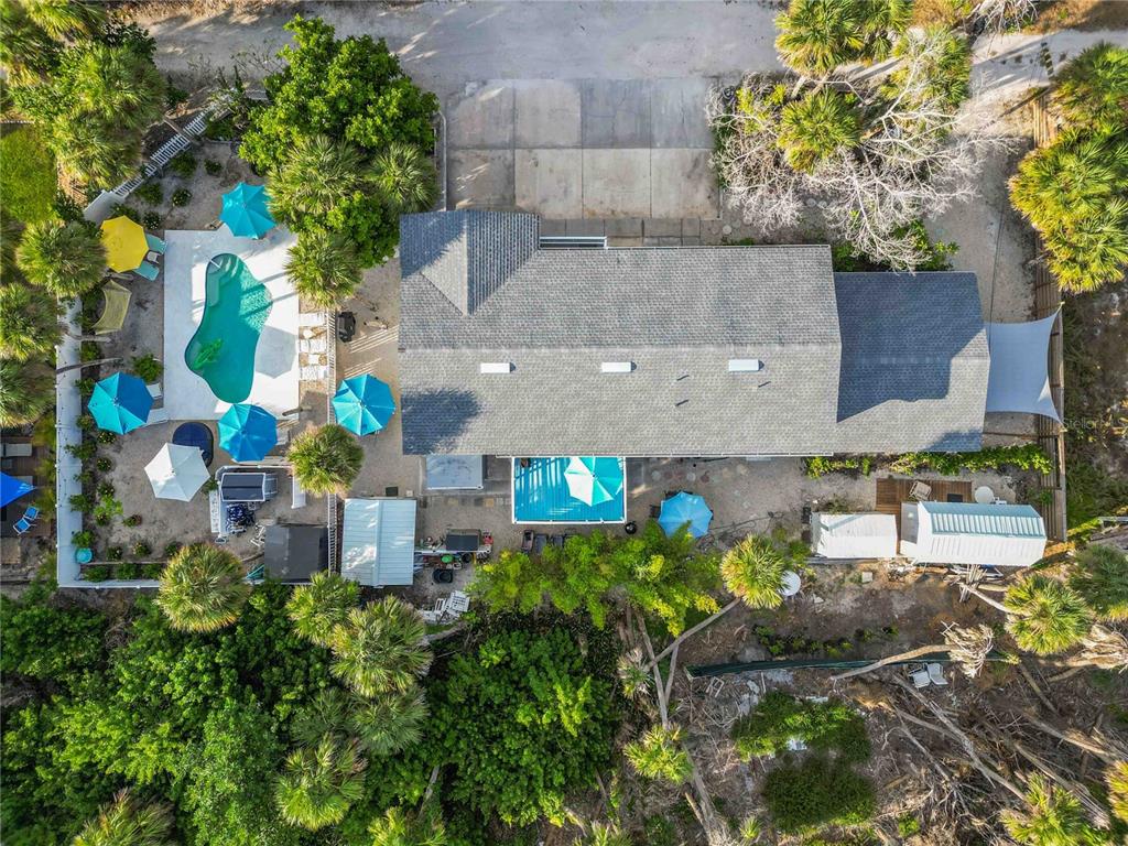 5075 North Beach Road, Unit B4 Englewood, FL 34223 - Photo 2 of 79 an aerial view of a house with a yard and a large tree