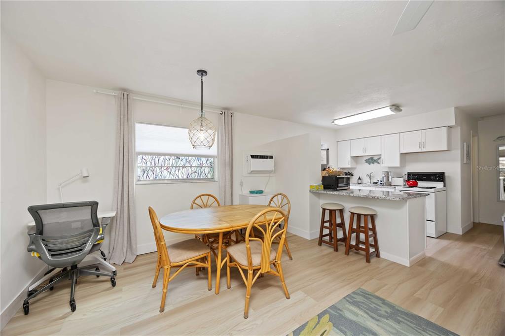 5075 North Beach Road, Unit B4 Englewood, FL 34223 - Photo 25 of 79 a view of a dining room with furniture and wooden floor