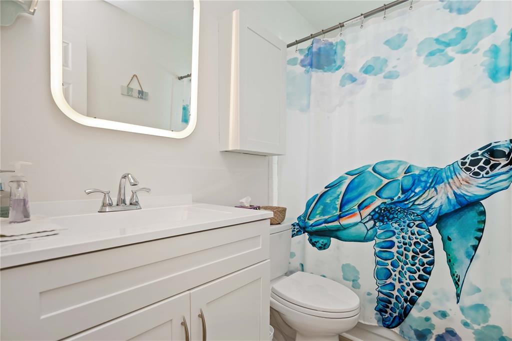 5075 North Beach Road, Unit B4 Englewood, FL 34223 - Photo 30 of 79 a bathroom with a sink a toilet and a mirror