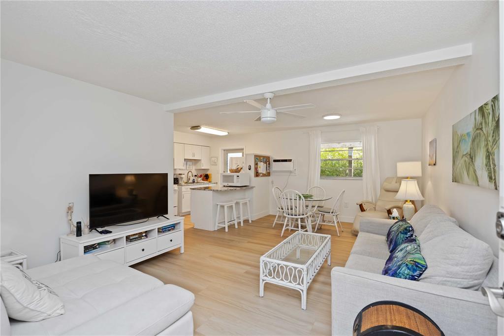 5075 North Beach Road, Unit B4 Englewood, FL 34223 - Photo 34 of 79 a living room with furniture and a flat screen tv