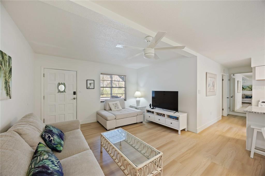 5075 North Beach Road, Unit B4 Englewood, FL 34223 - Photo 36 of 79 a living room with furniture and a flat screen tv