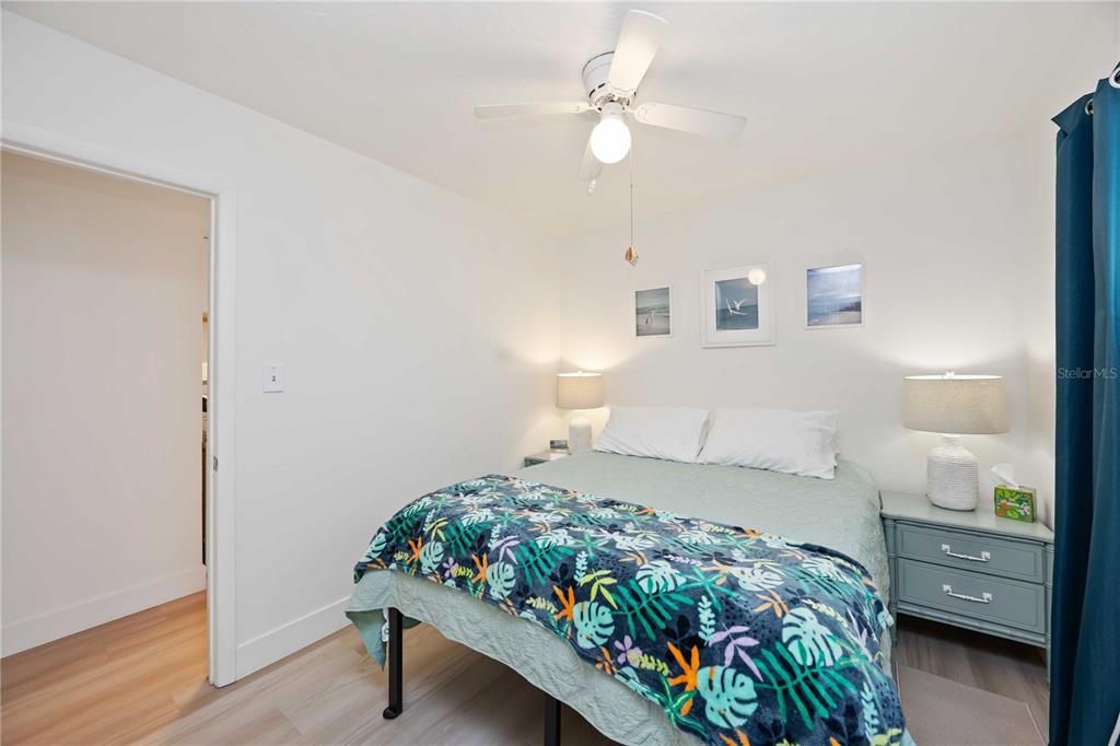 5075 North Beach Road, Unit B4 Englewood, FL 34223 - Photo 41 of 79 a bedroom with a bed and a chandelier