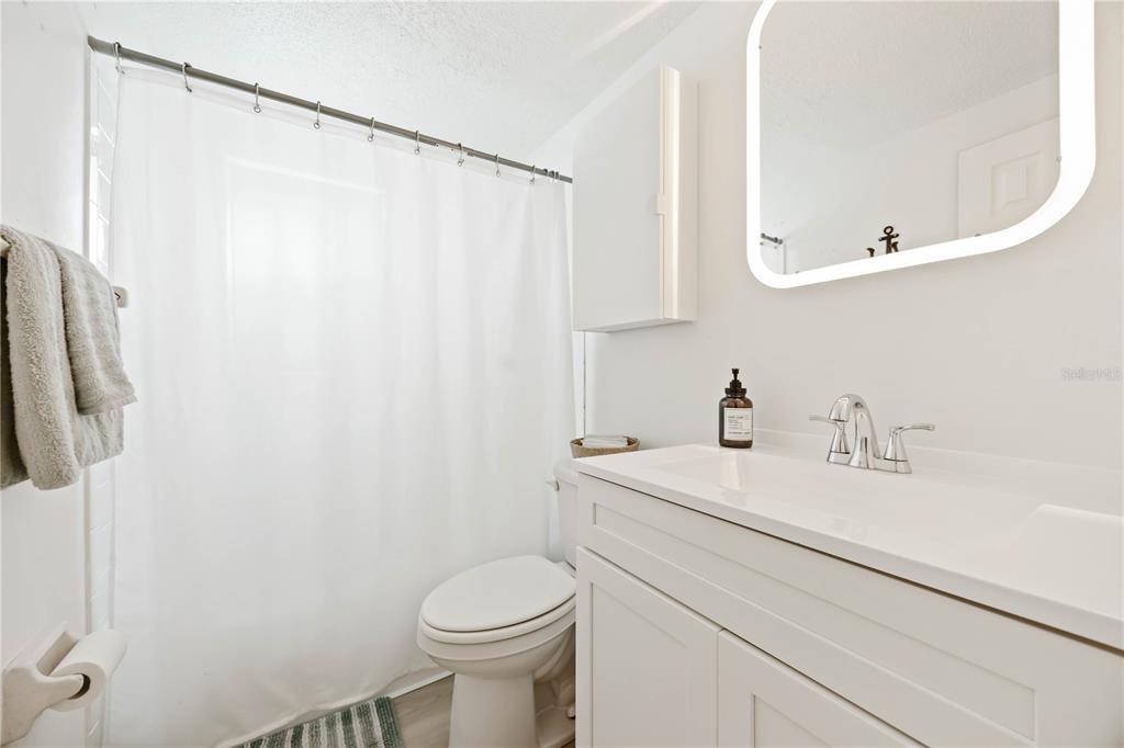 5075 North Beach Road, Unit B4 Englewood, FL 34223 - Photo 42 of 79 a bathroom with a sink a toilet and a mirror