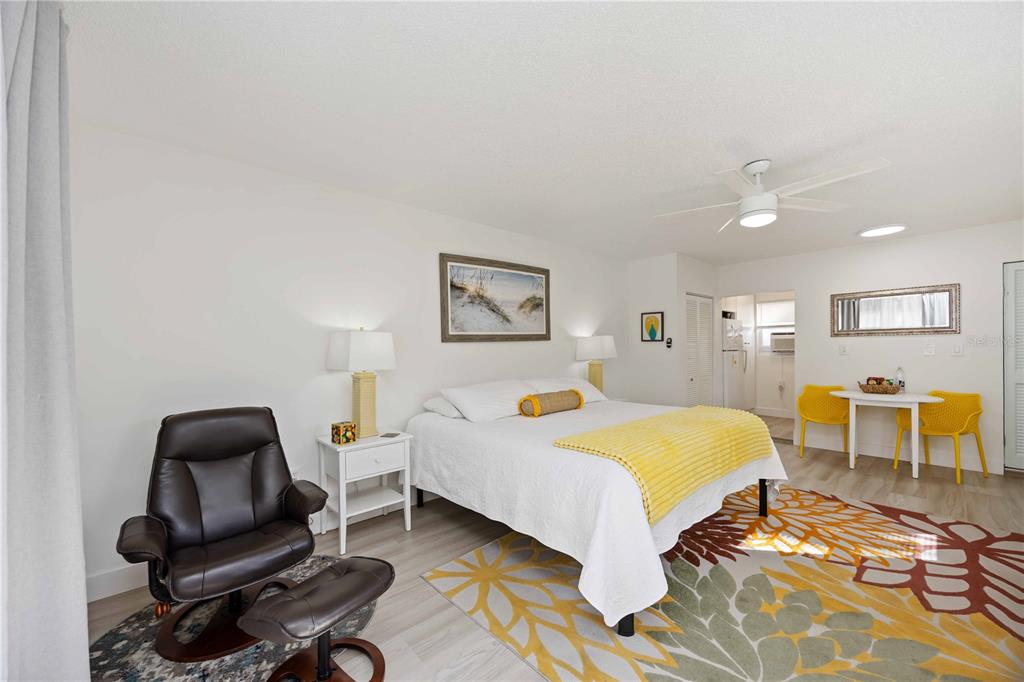 5075 North Beach Road, Unit B4 Englewood, FL 34223 - Photo 44 of 79 a bedroom with a bed a table and chair