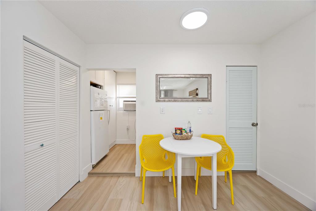 5075 North Beach Road, Unit B4 Englewood, FL 34223 - Photo 45 of 79 a view of a dining room with furniture and wooden floor