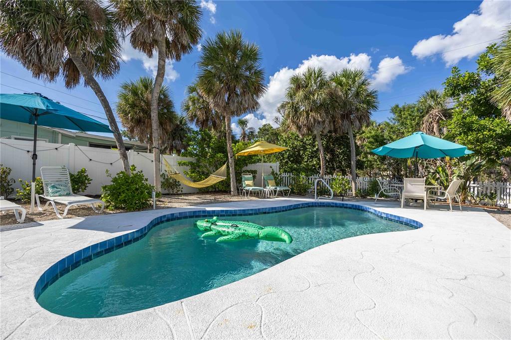 5075 North Beach Road, Unit B4 Englewood, FL 34223 - Photo 49 of 79 a view of a swimming pool with a patio