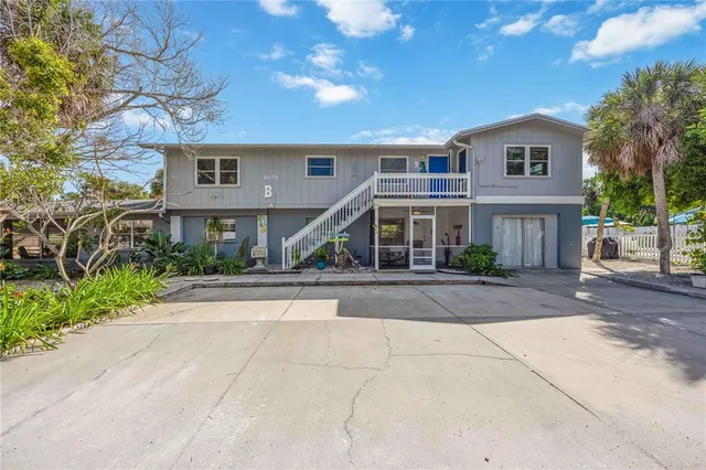 a view of front door and deck with patio