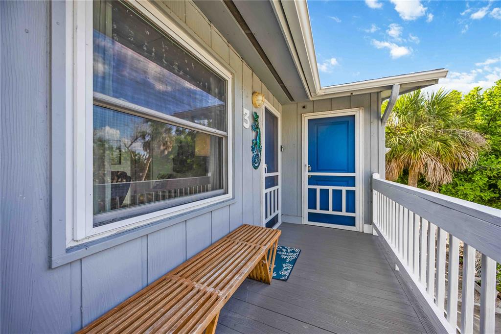 5075 North Beach Road, Unit B4 Englewood, FL 34223 - Photo 9 of 79 a view of front door and deck with patio