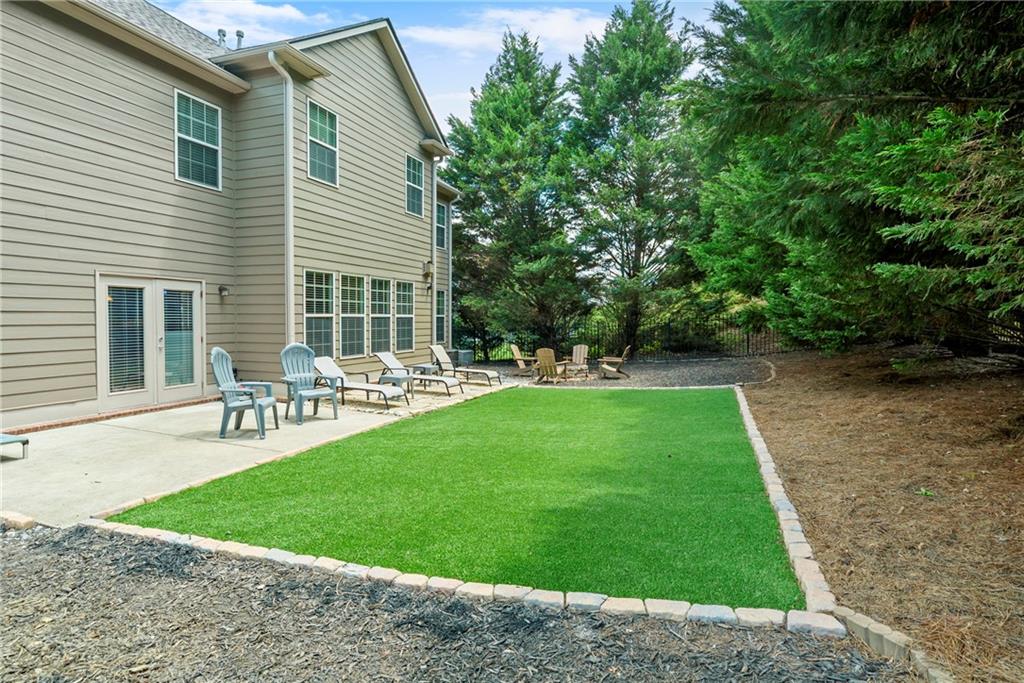3715 Slater Street Cumming, GA 30041 - Photo 11 of 36 a view of a patio with table and chairs and potted plants