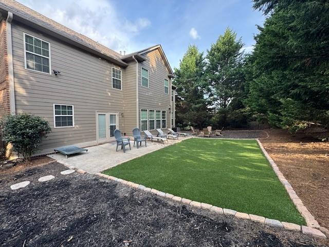 3715 Slater Street Cumming, GA 30041 - Photo 13 of 36 a backyard of a house with table and chairs