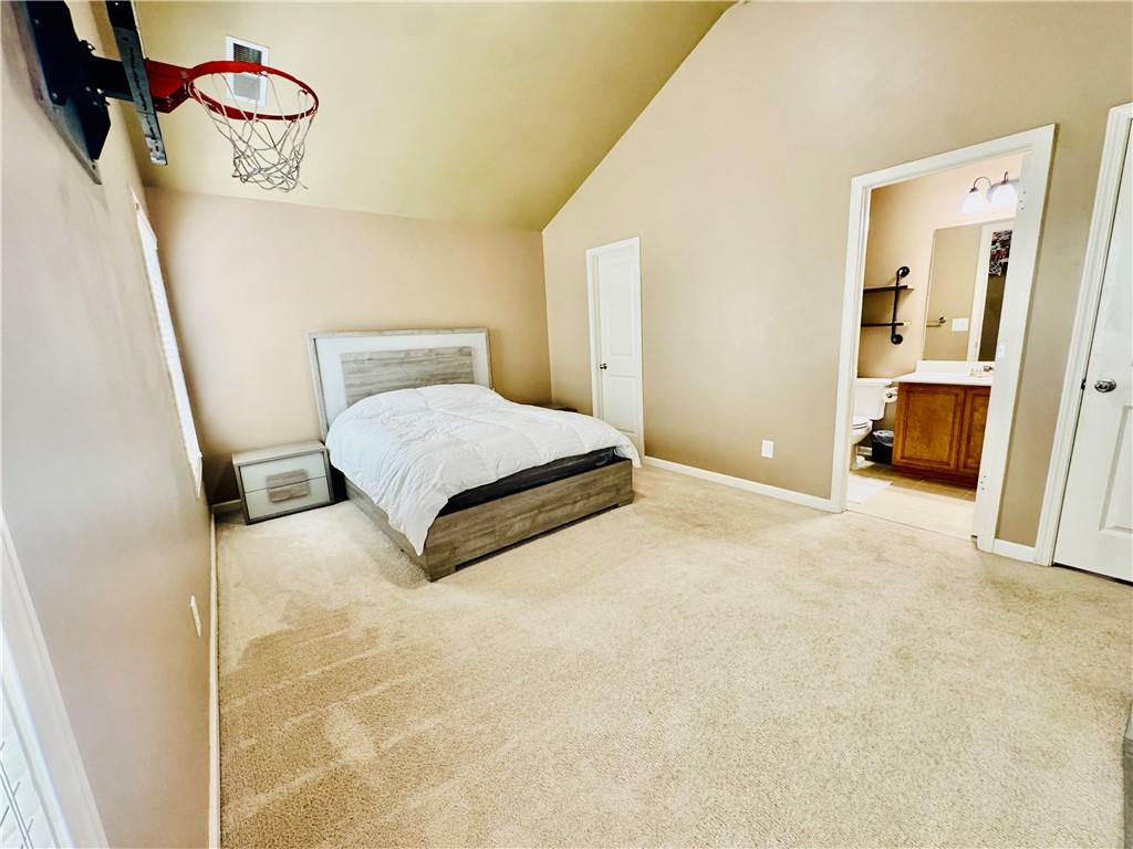 3715 Slater Street Cumming, GA 30041 - Photo 34 of 36 a spacious bedroom with a bed and dresser next to a window