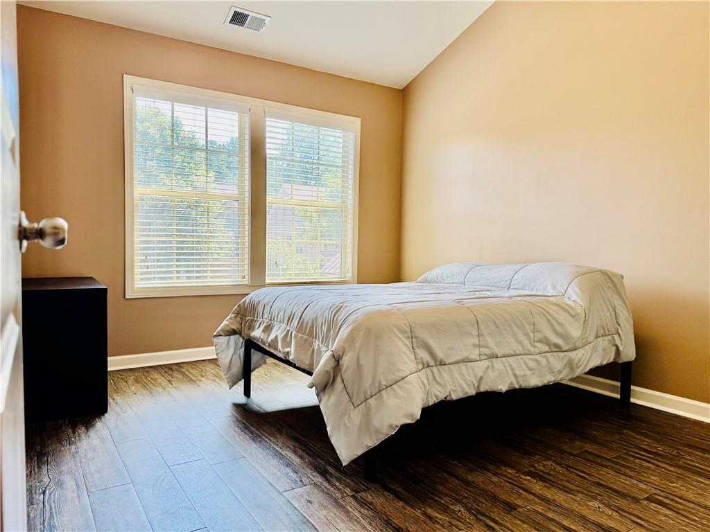 3715 Slater Street Cumming, GA 30041 - Photo 36 of 36 a bed sitting in a bedroom next to a window