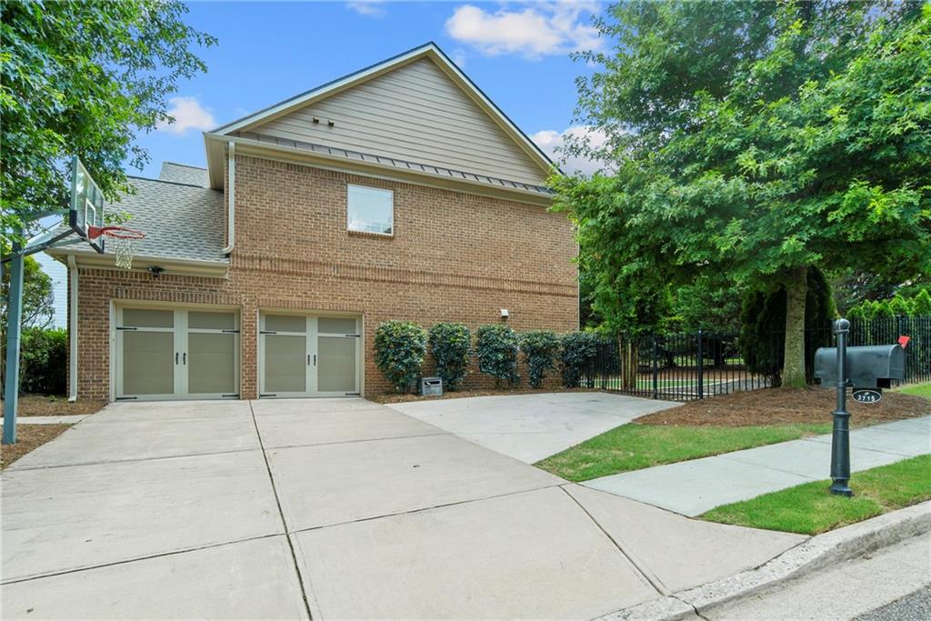 3715 Slater Street Cumming, GA 30041 - Photo 5 of 36 a backyard of a house with plants and tree