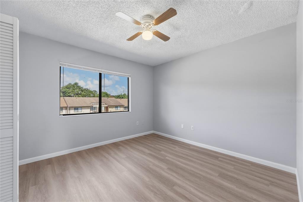 4799 Sisson Road Titusville, FL 32780 - Photo 15 of 23 wooden floor in an empty room with a window