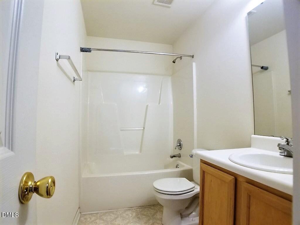 2100 Ramsgate Street Raleigh, NC 27603 - Photo 8 of 13 a bathroom with a sink and mirror with bathtub