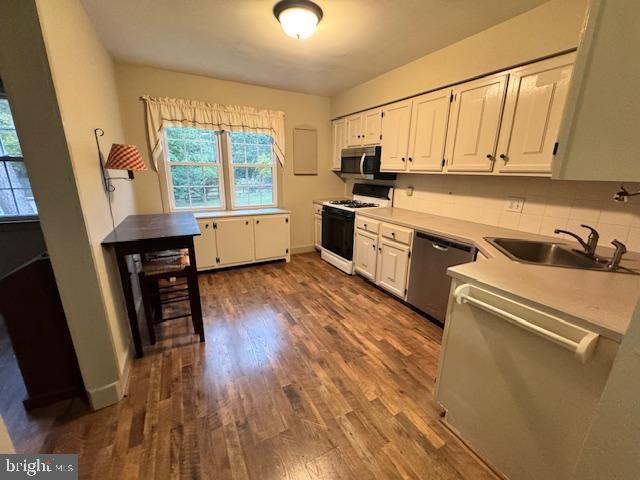 338 Ridge Road Browns Mills, NJ 08015 - Photo 14 of 38 a kitchen with wooden floors and white appliances