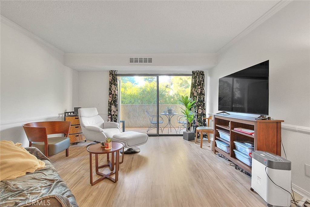700 West 3rd Street, Unit A111 Santa Ana, CA 92701 - Photo 2 of 15 a living room with furniture and a flat screen tv